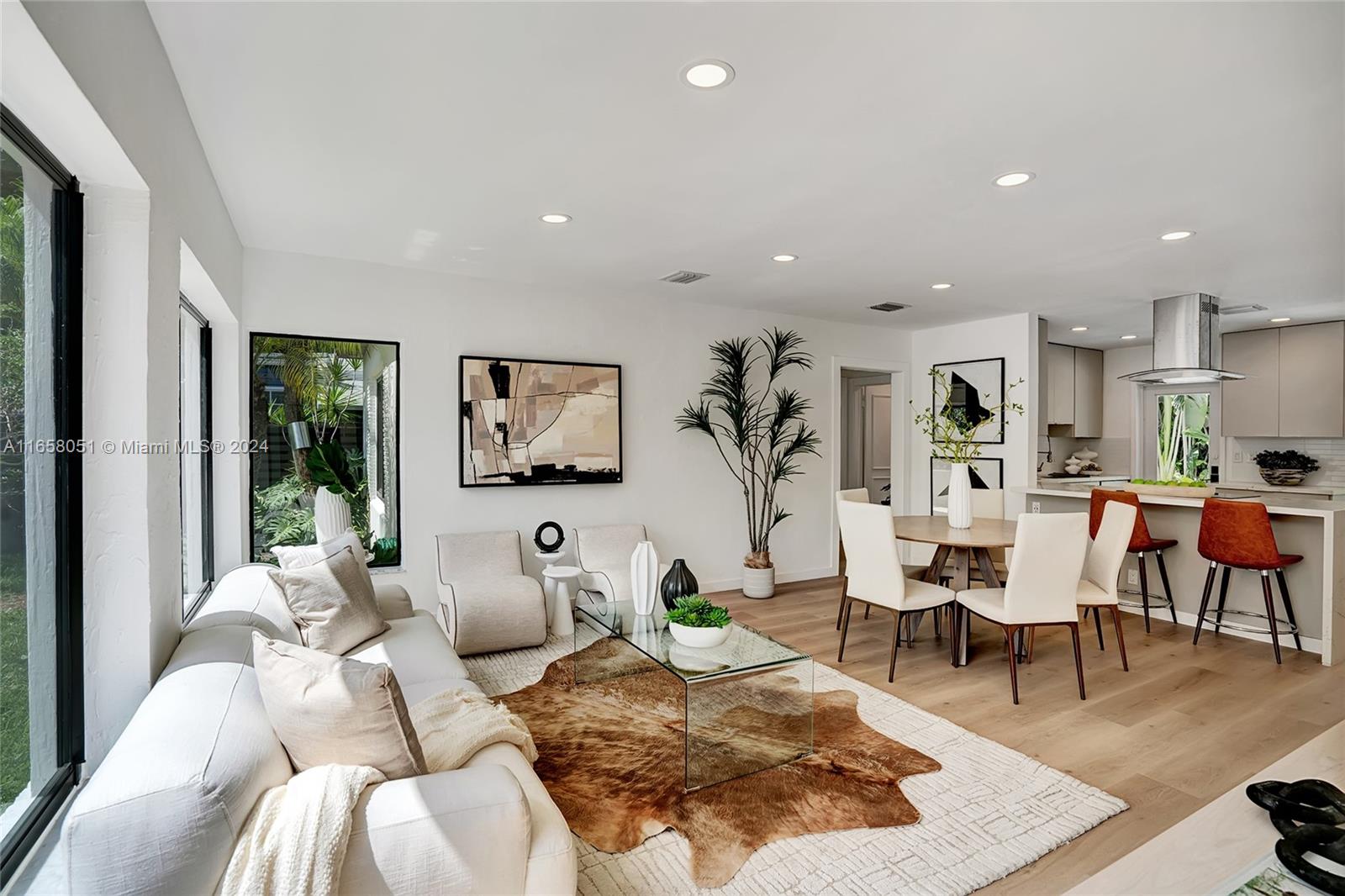 a living room with furniture wooden floor and a table