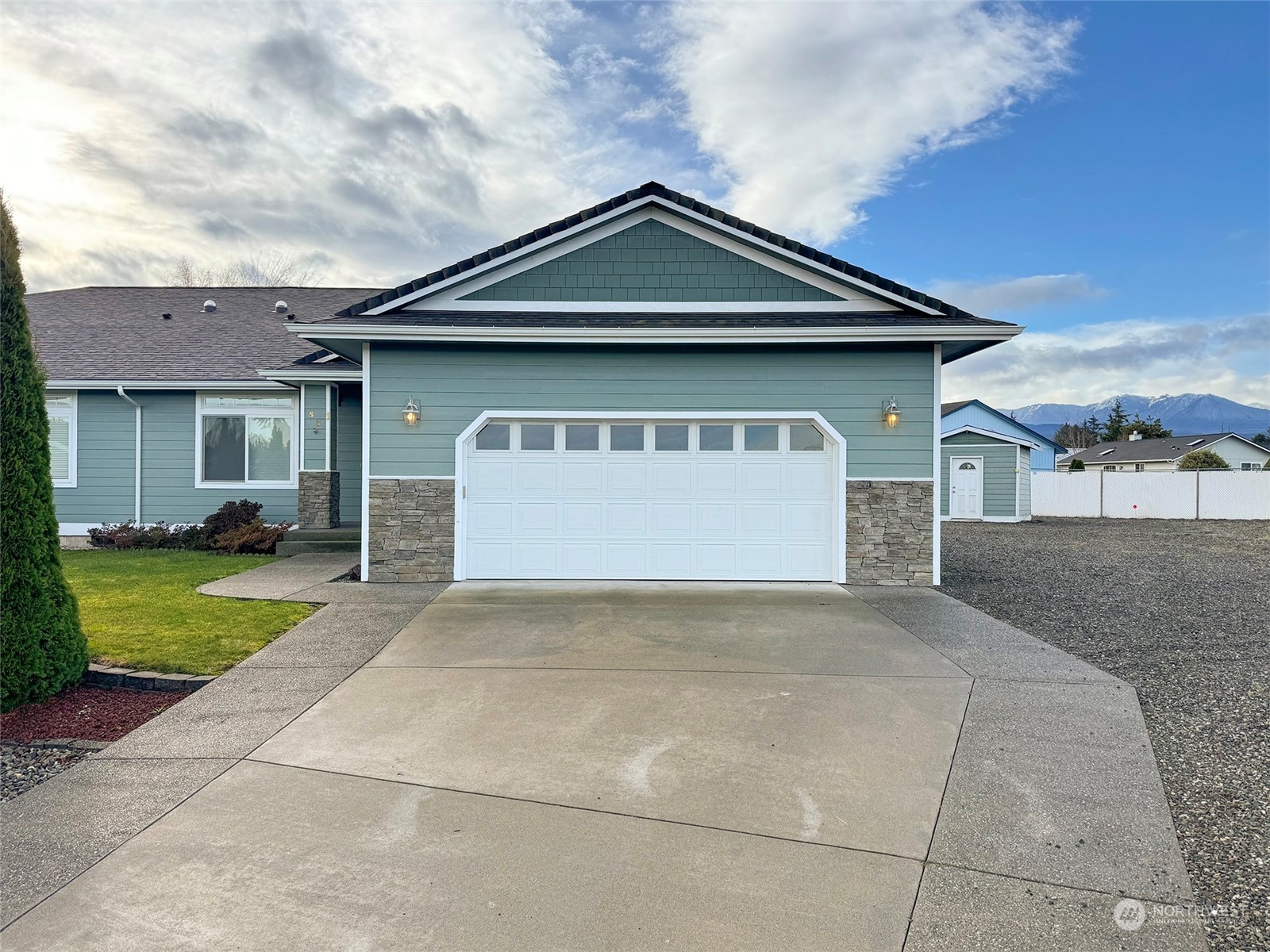 a front view of a house with a yard and garage