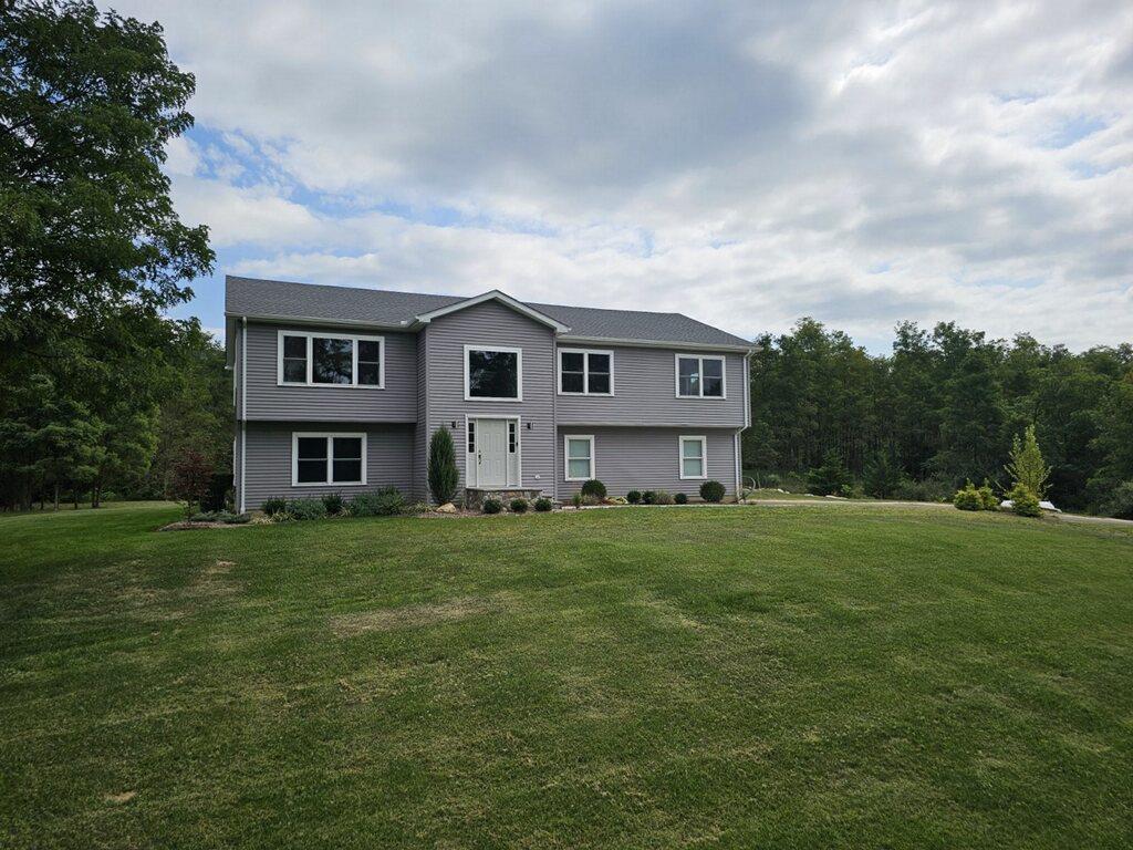 View of front of property with a front yard