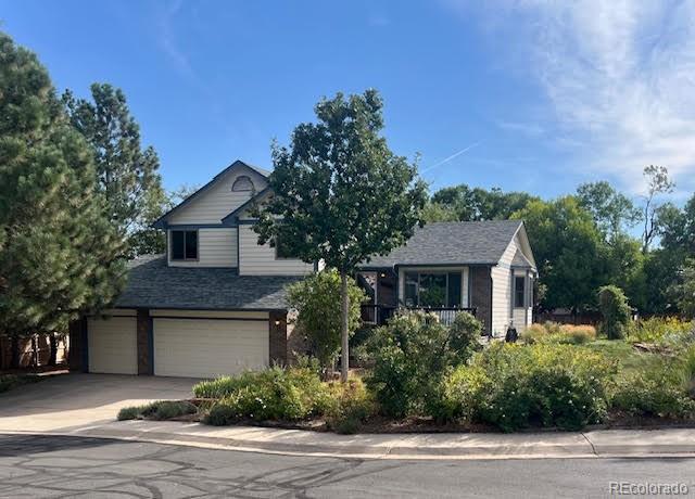 a front view of a house with a yard garage and outdoor seating