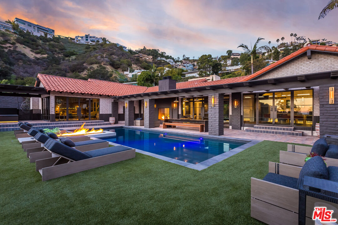 a view of an house with swimming pool yard and patio