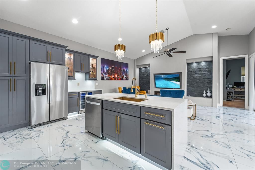 a kitchen with stainless steel appliances a refrigerator sink and microwave