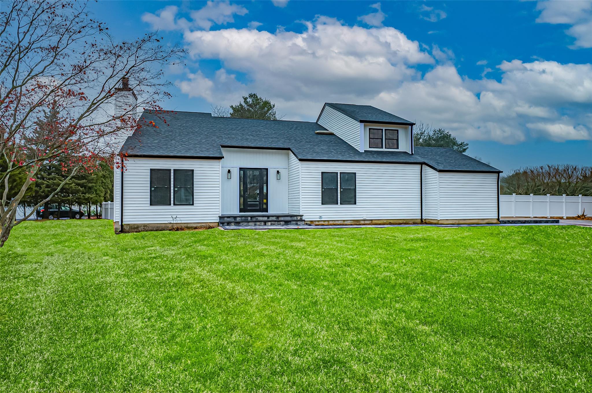 a front view of house with yard and green space