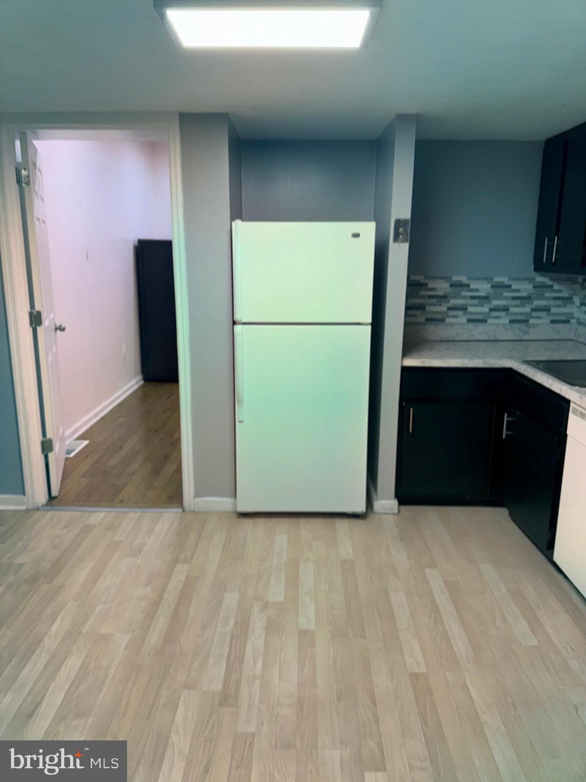 a kitchen with a refrigerator and a sink