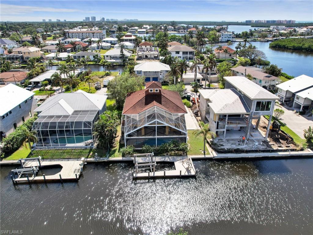 an aerial view of a house with a garden and lake view