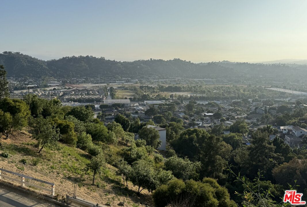 a view of a mountain in the distance in a field