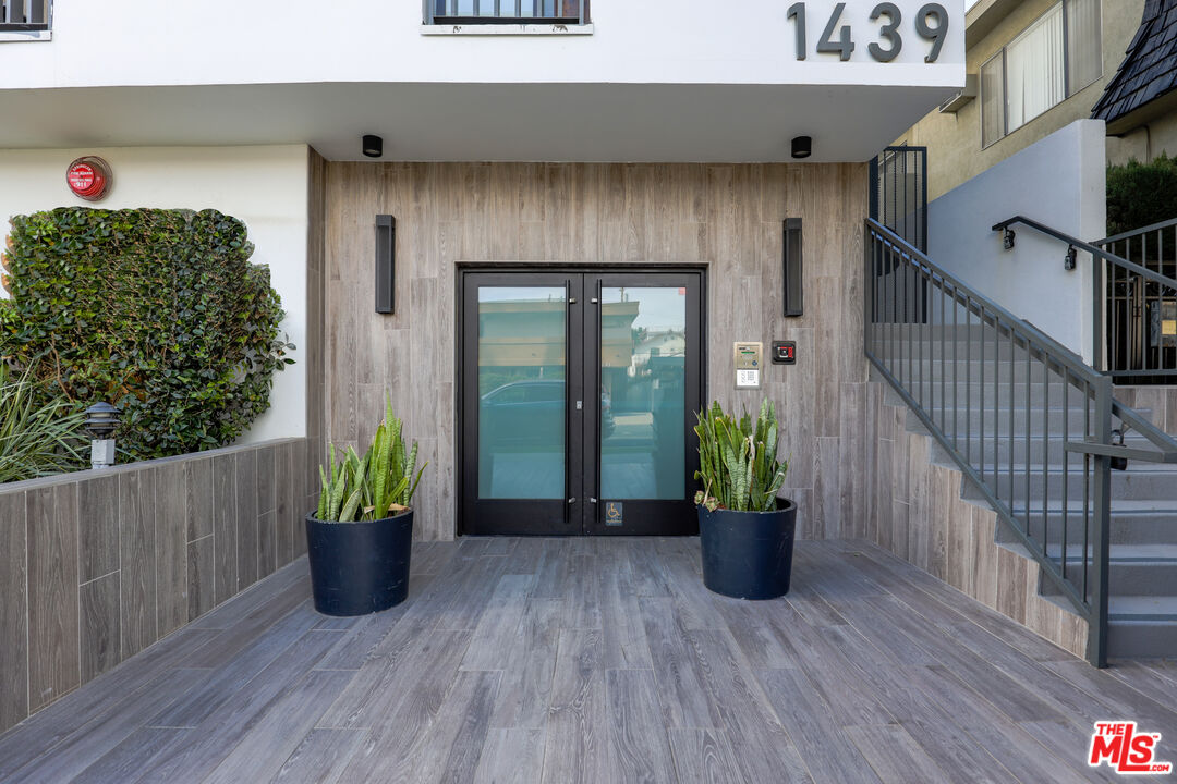 a view of a house with entryway and wooden floor