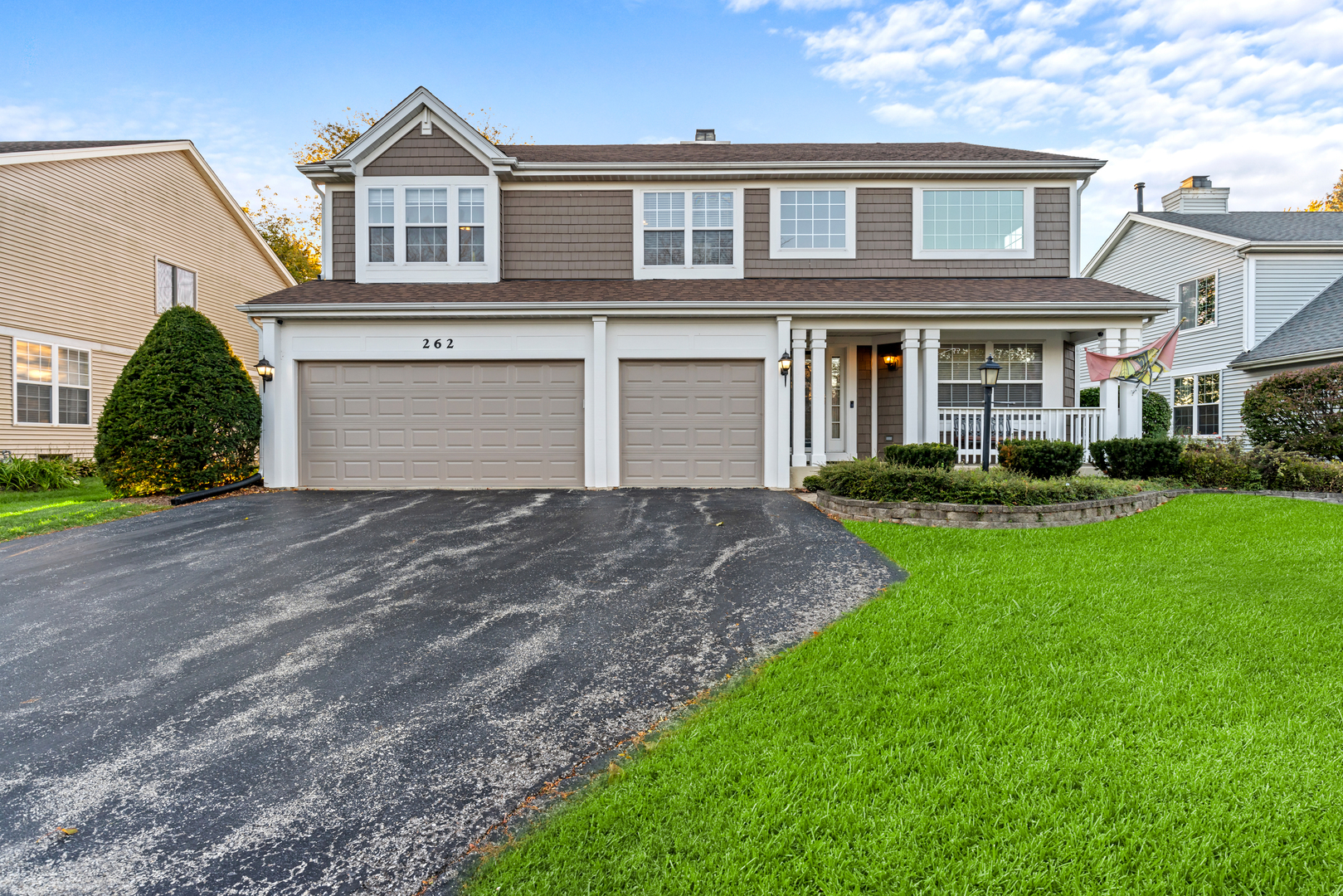 a front view of a house with a yard and garage