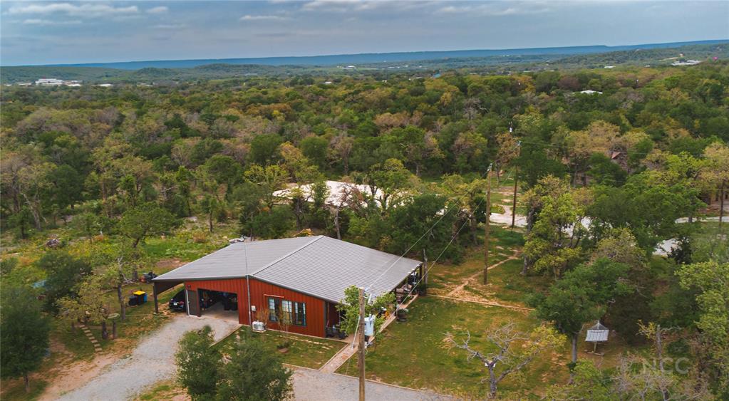 an aerial view of a house with a yard