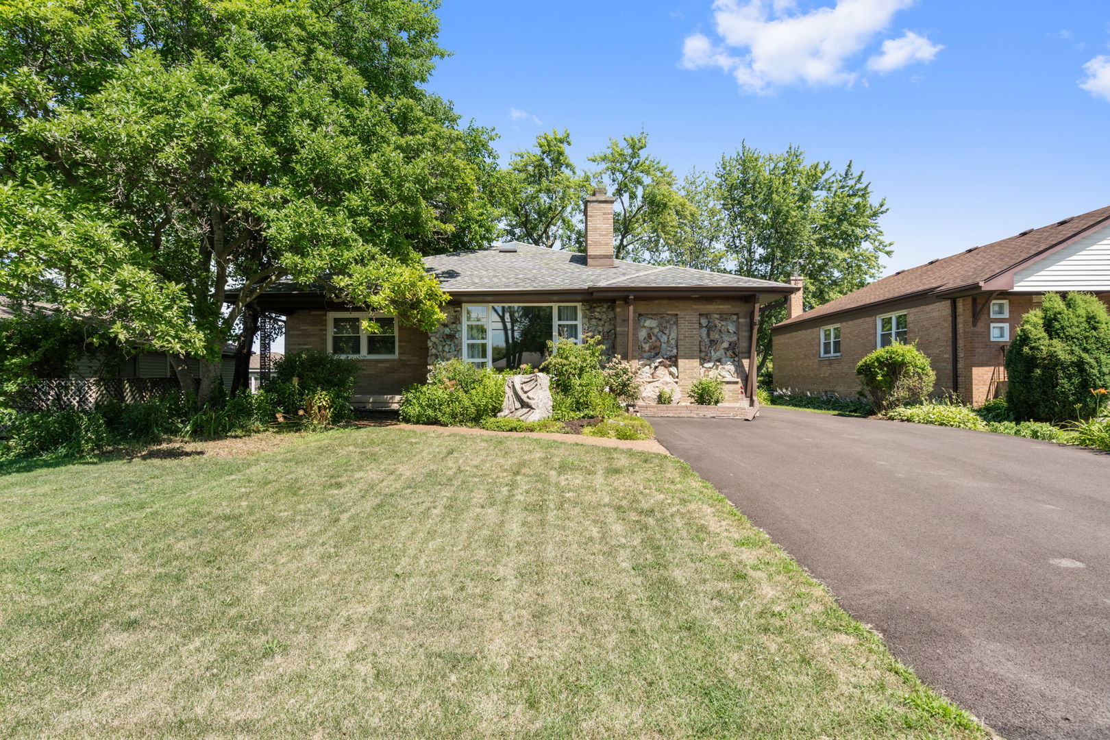 a front view of a house with a garden