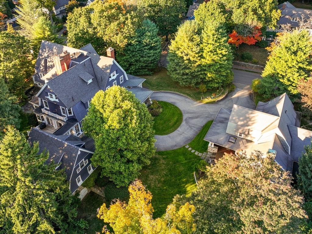 an aerial view of a house with a yard and garden