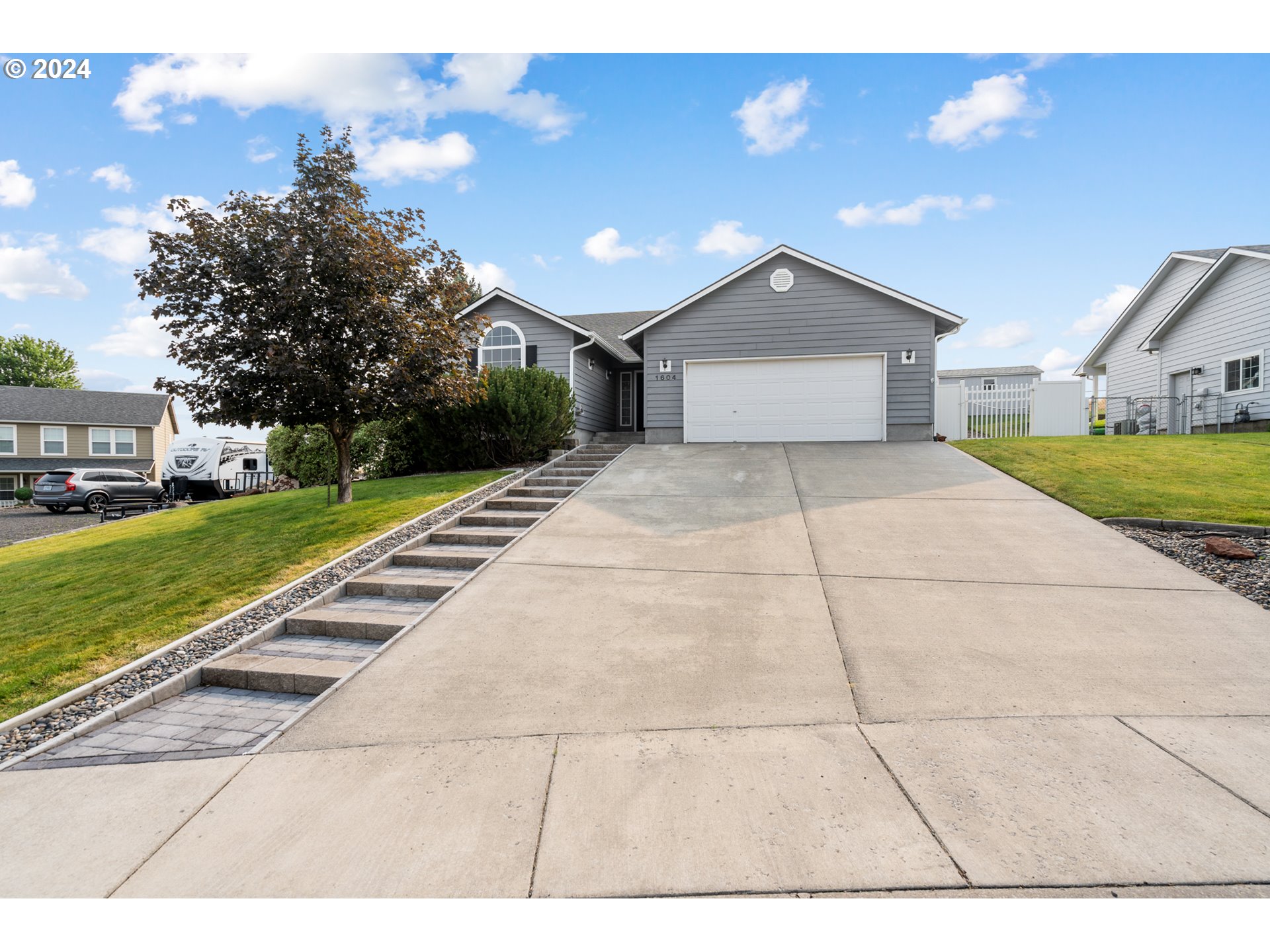 a front view of a house with a yard and garage