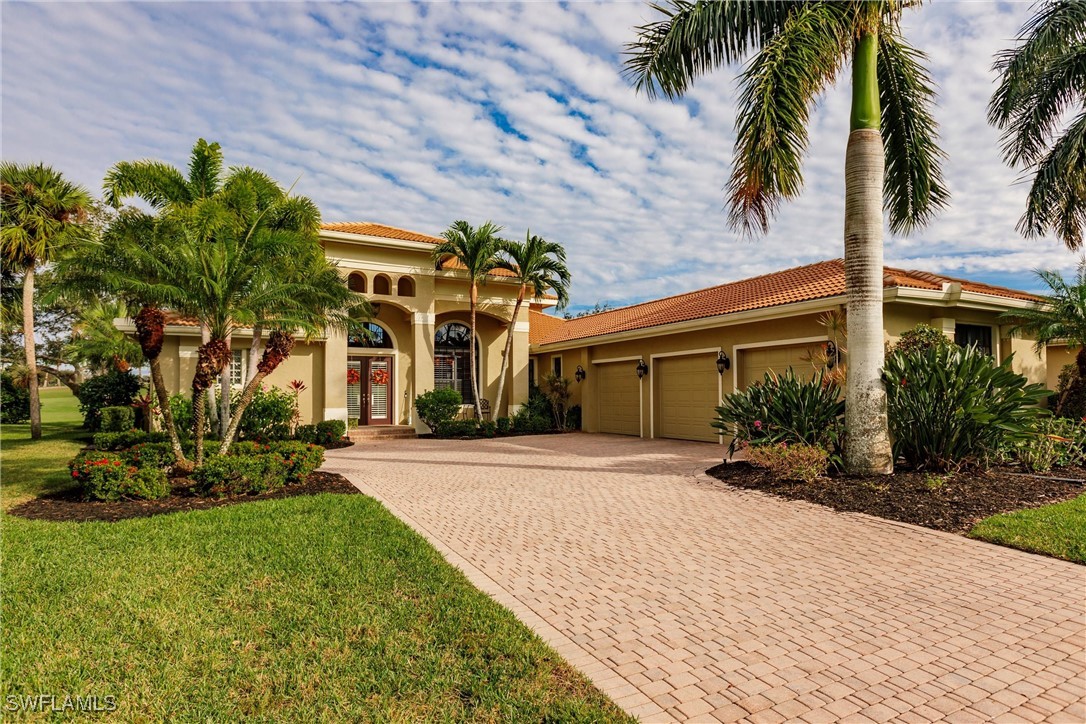 a front view of a house with a yard and palm trees