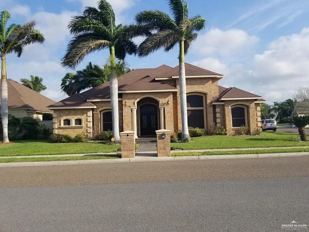 a front view of house with yard and green space