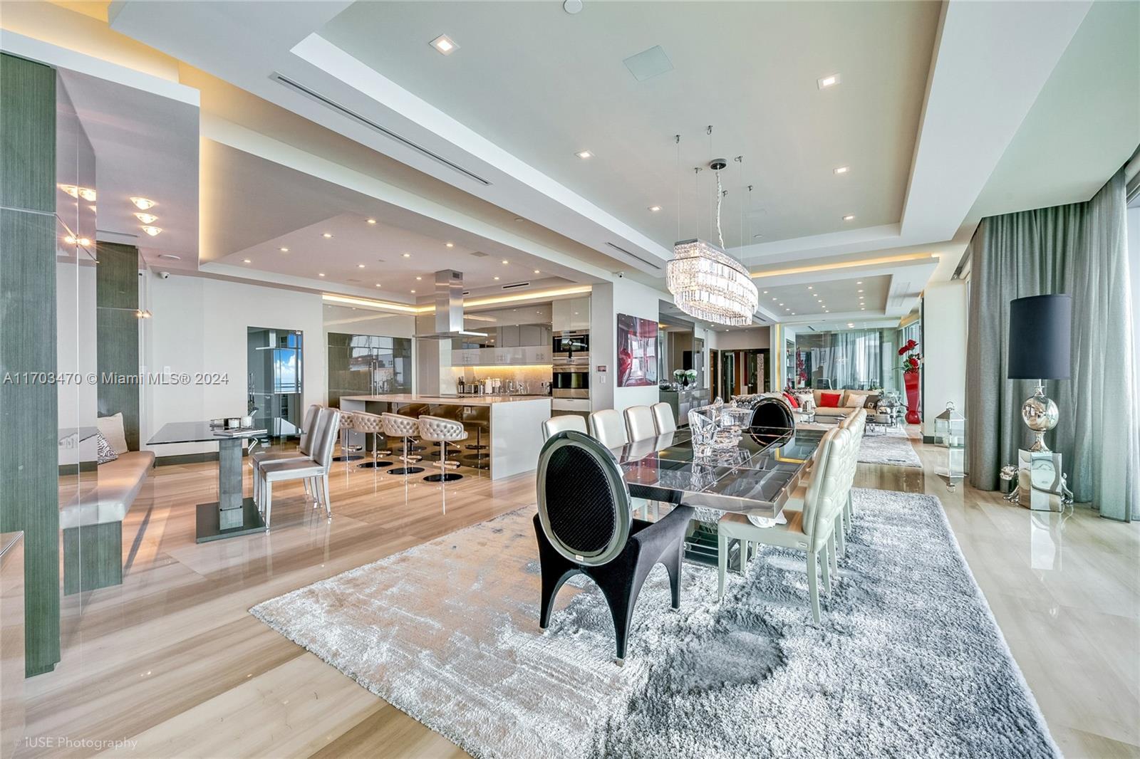 a living room with furniture a clock and a dining table