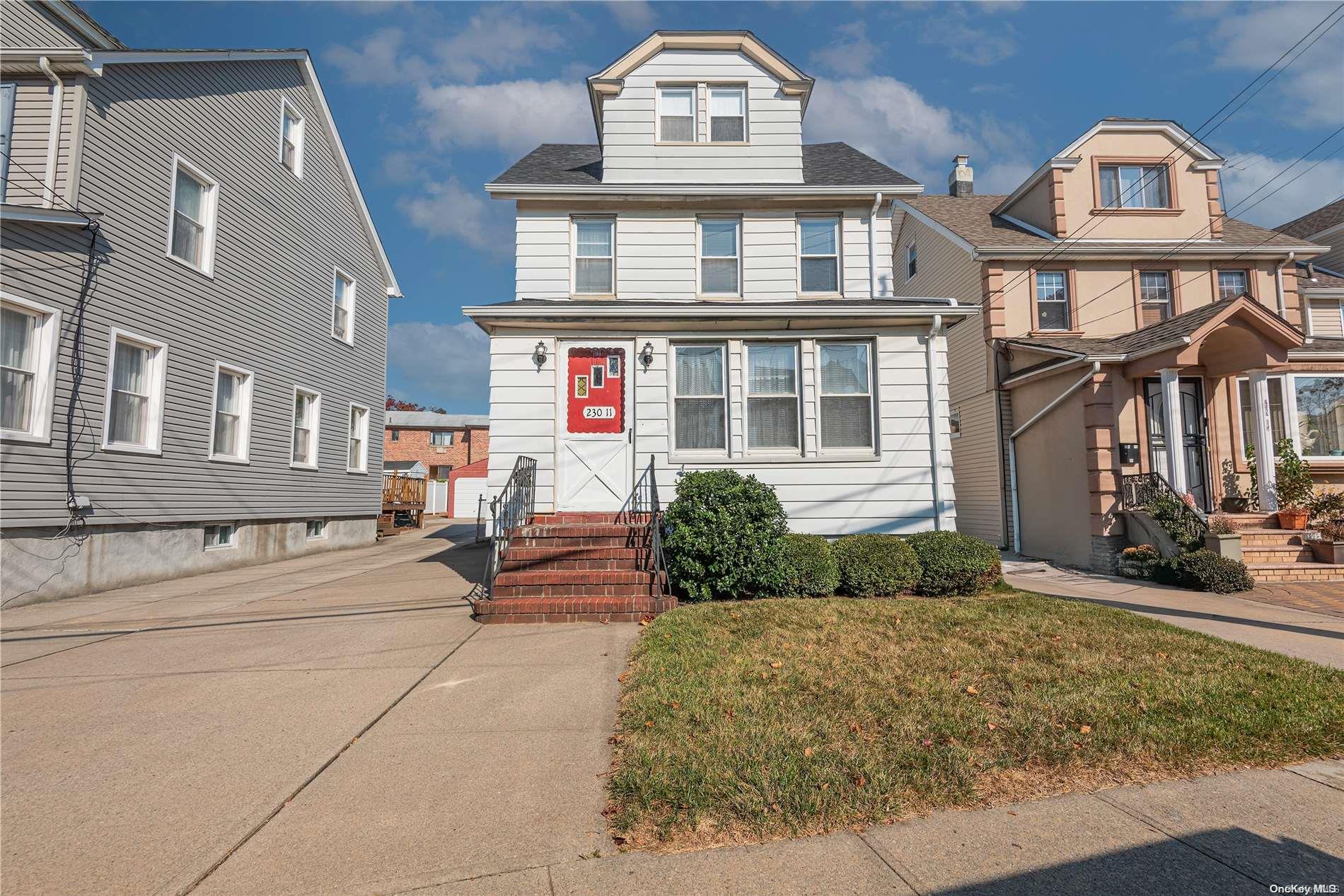 a front view of a residential apartment building with a yard