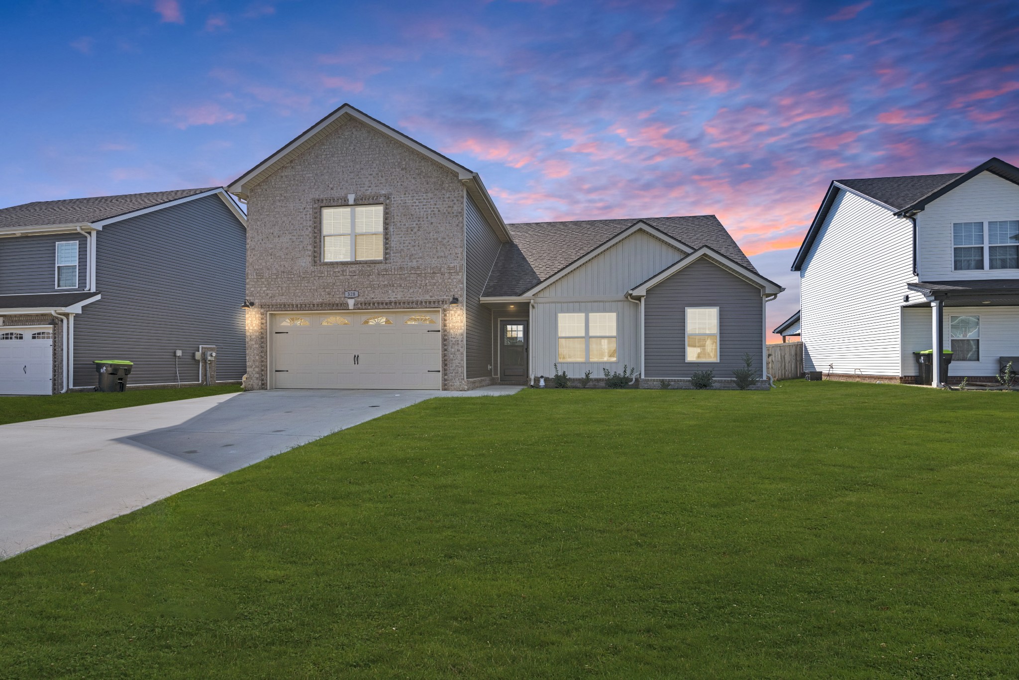 a front view of a house with a yard and garage