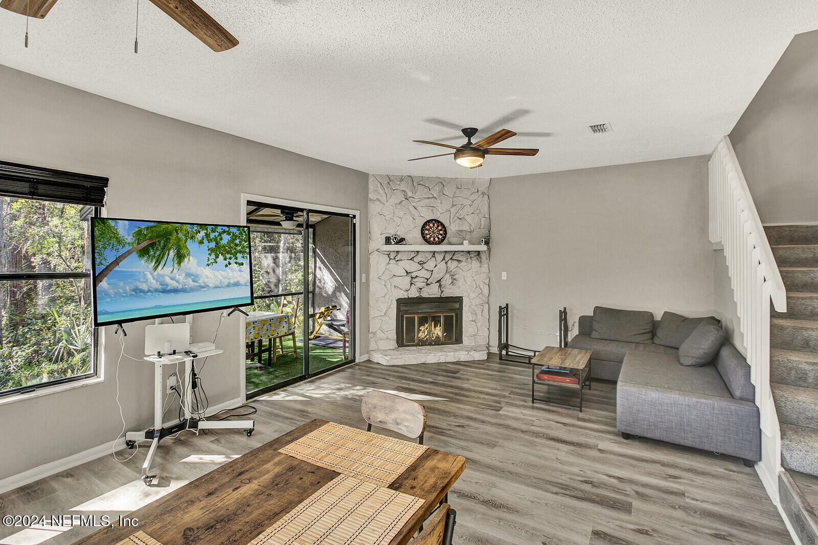 a living room with furniture a fireplace and a flat screen tv