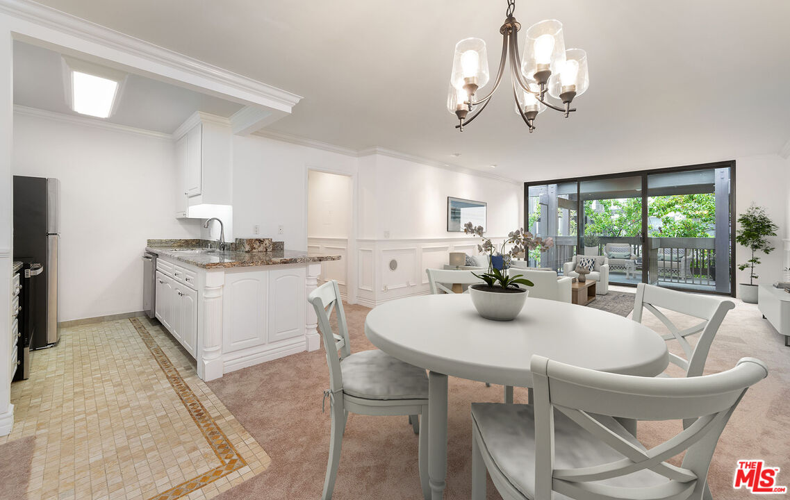 a kitchen with a table chairs stove and refrigerator