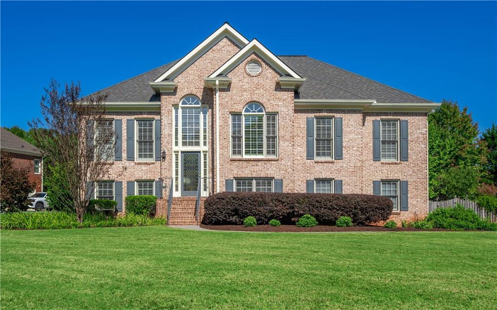 a front view of a house with a yard