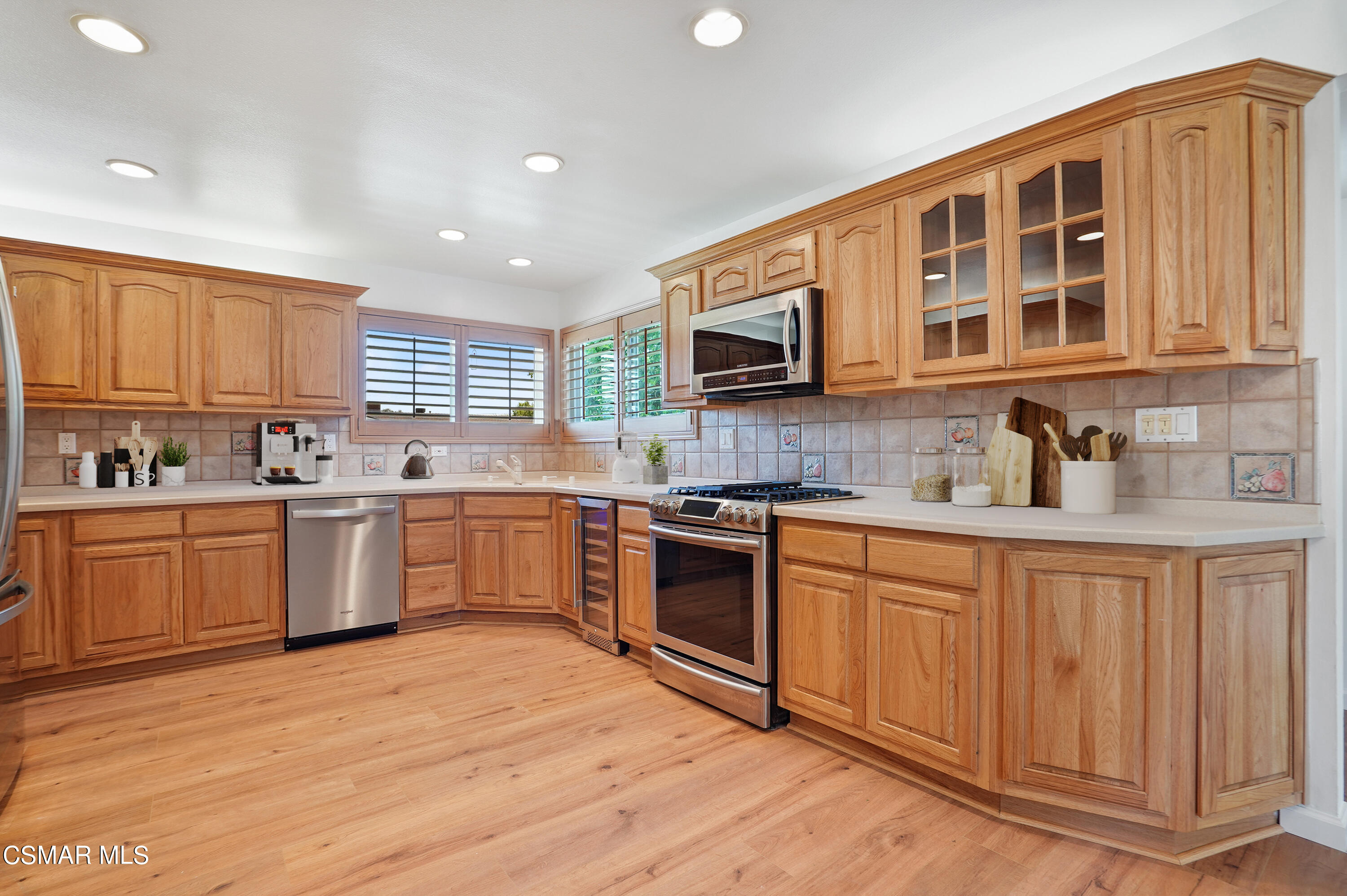 a kitchen with a stove top oven a sink and cabinets