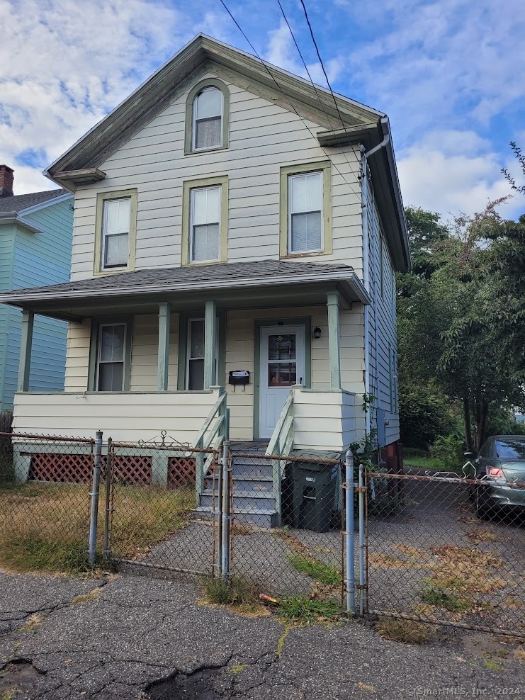 a view of a house with a yard and furniture