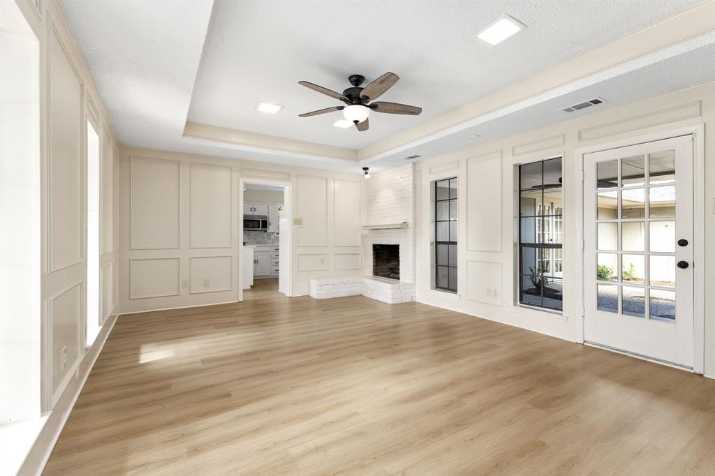 a view of an empty room with window and cabinet