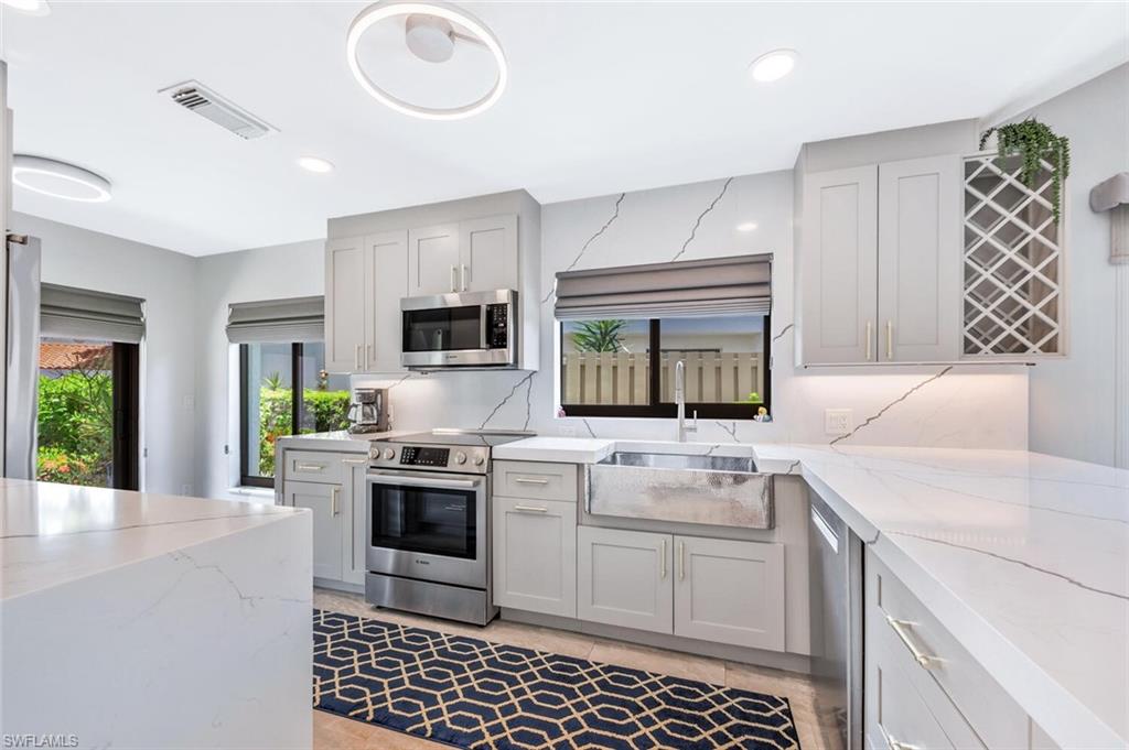 a kitchen with a stove a sink and a microwave