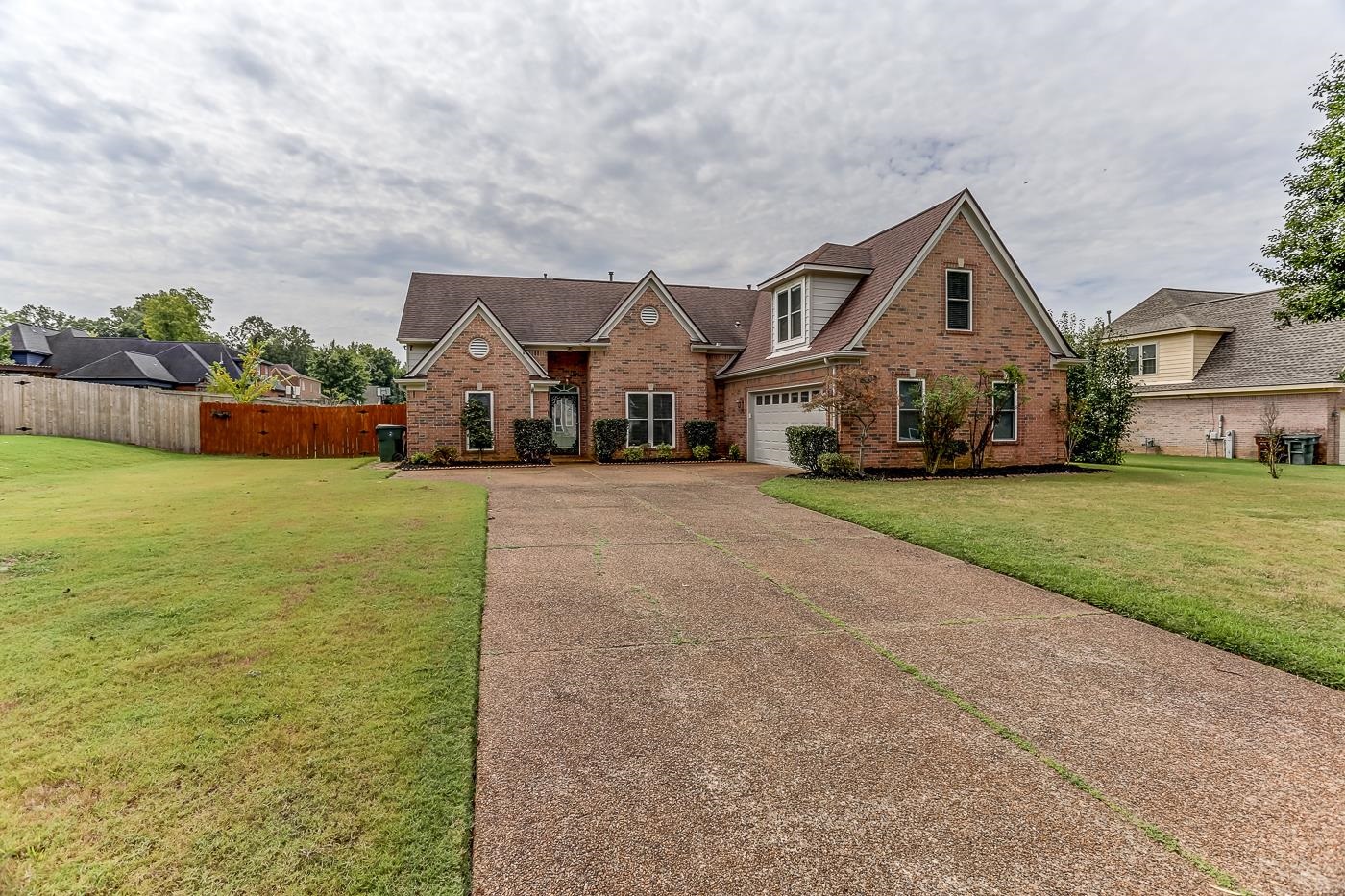 View of front of home with a garage and a front yard