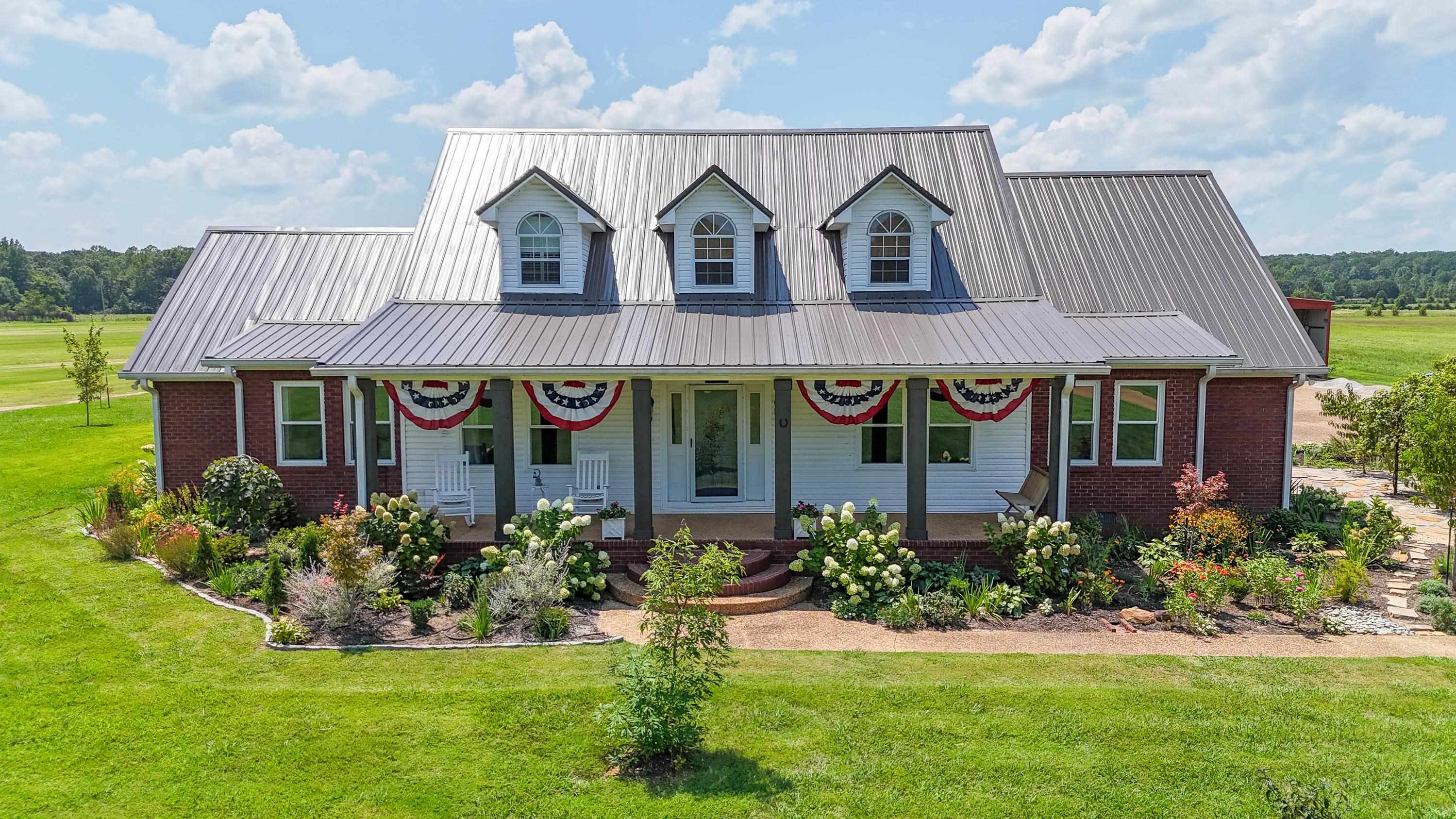 a front view of a house with garden