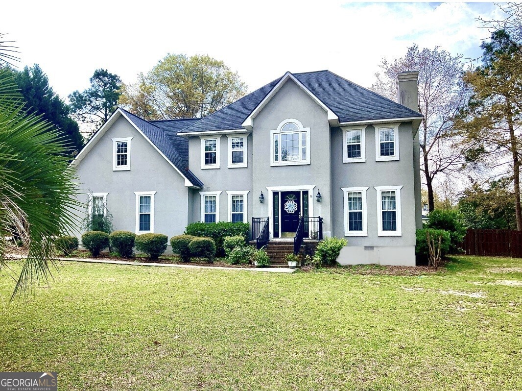 a front view of a house with garden