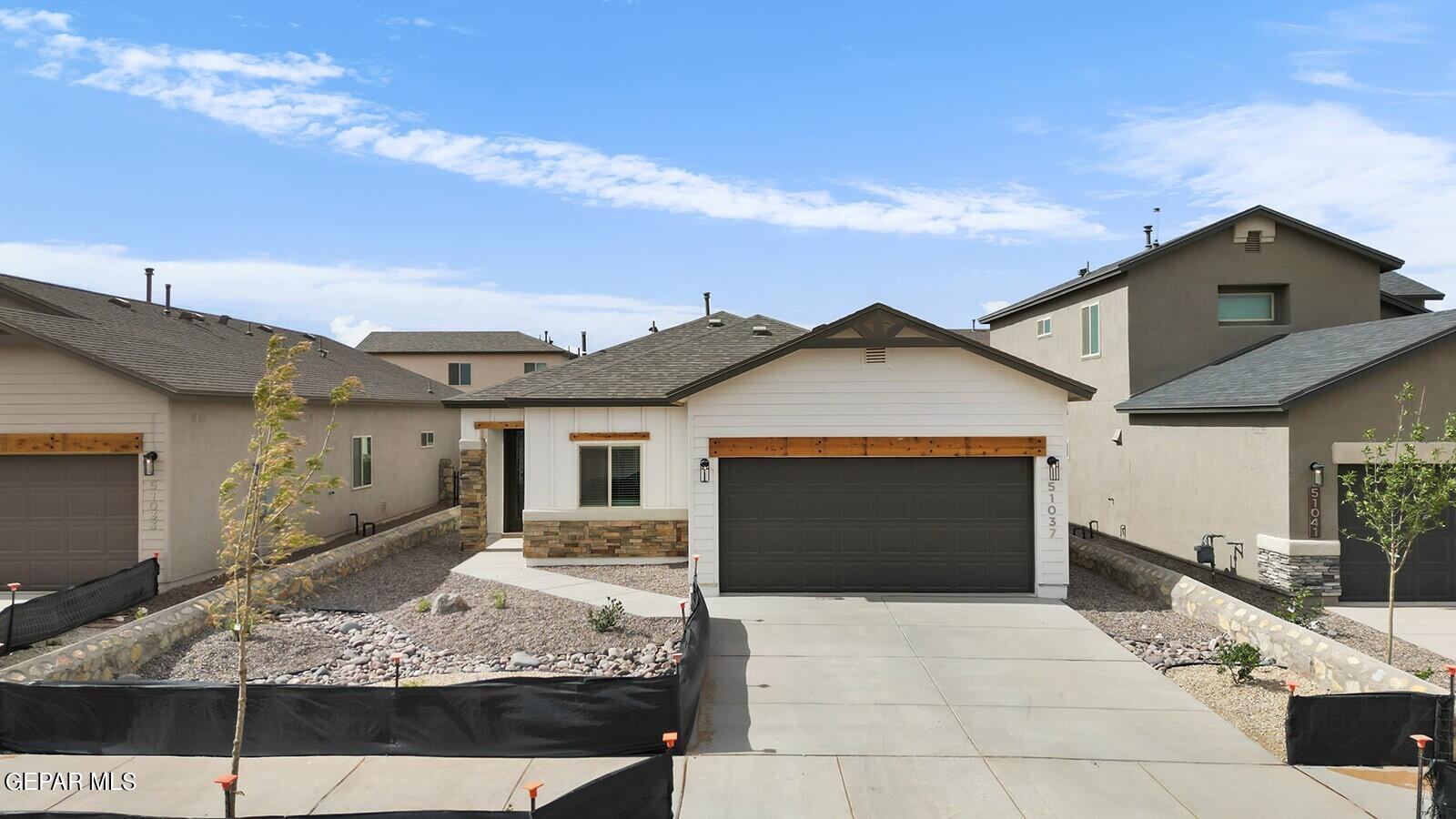 a view of a house with a yard and garage