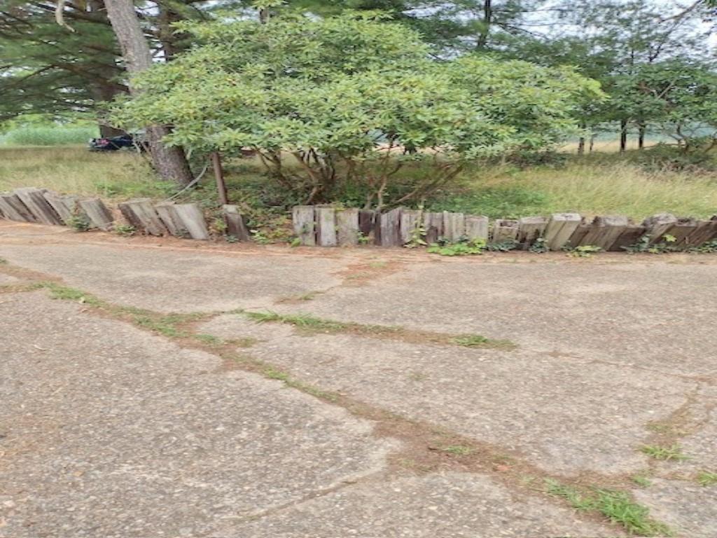 a wooden bench sitting in middle of a yard