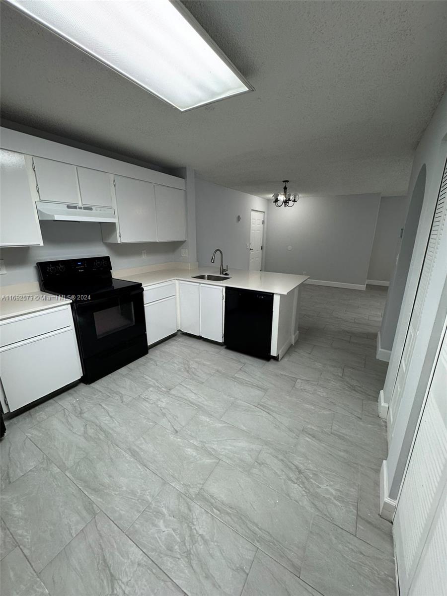 a kitchen with a cabinets and white appliances