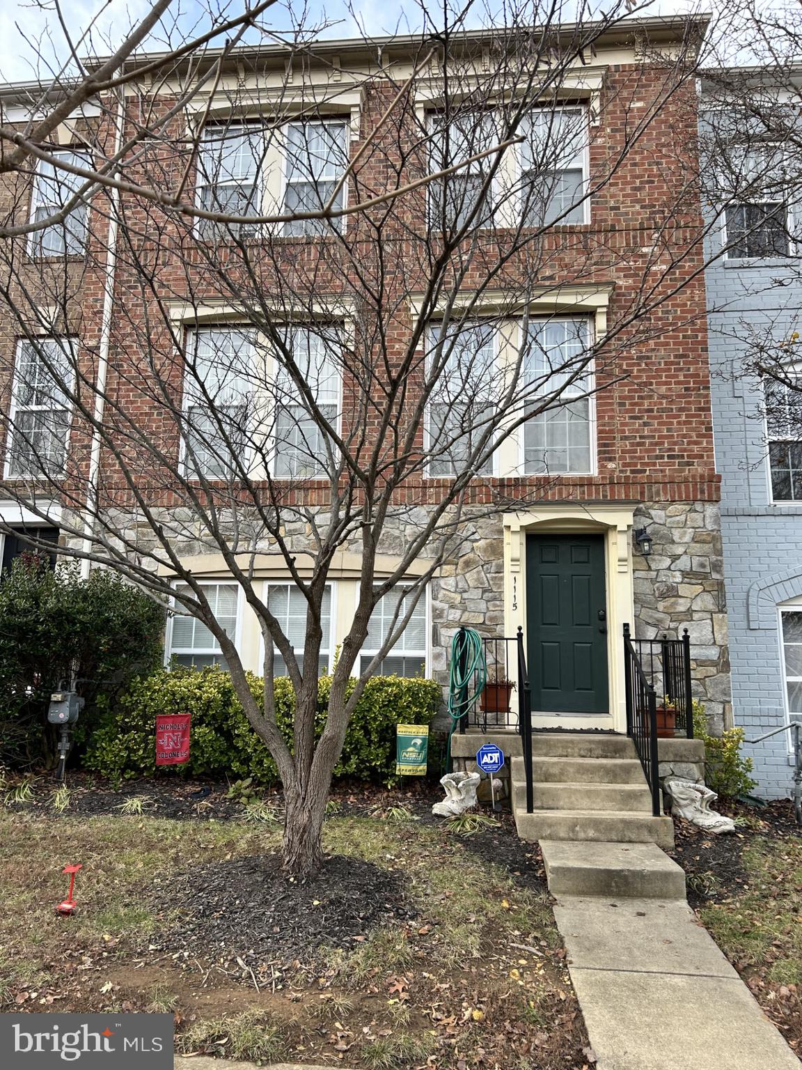 a view of a house with a yard and tree s