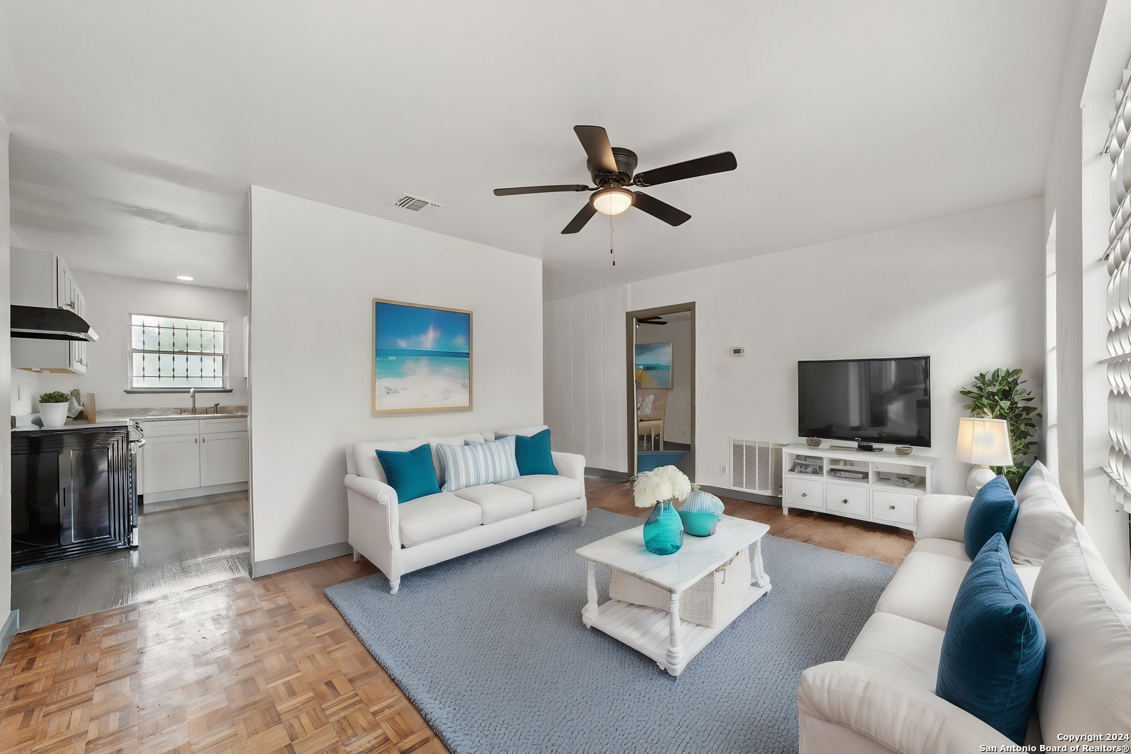 a living room with furniture and a flat screen tv