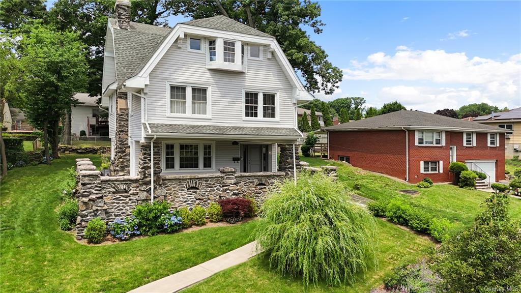 a front view of a house with a garden