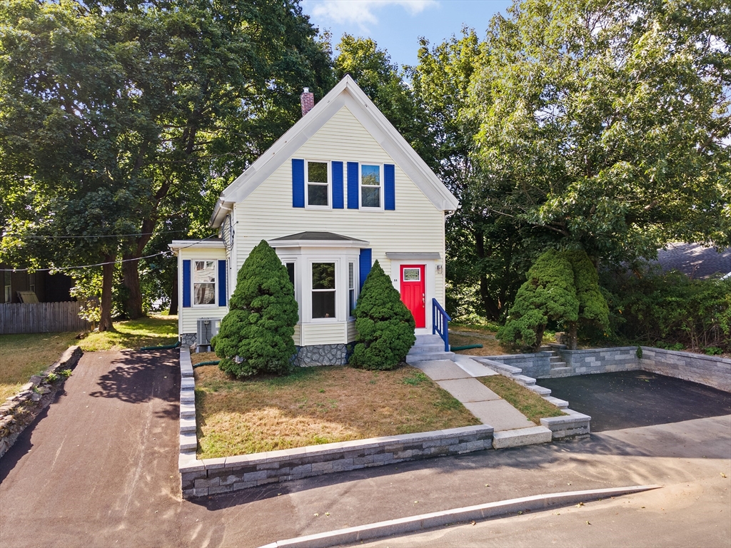 a front view of a house with garden