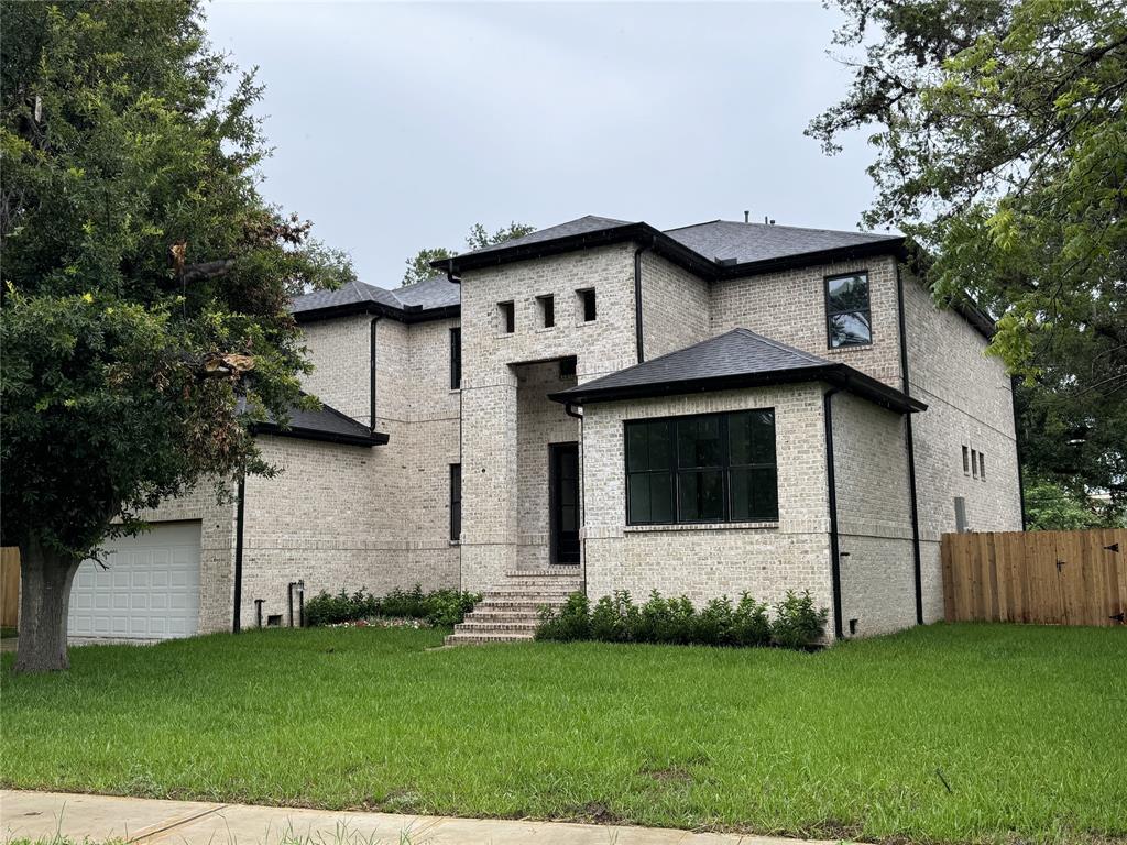 a front view of a house with a garden