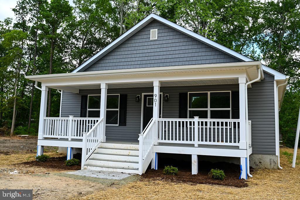 a view of a house with a yard deck and a garden