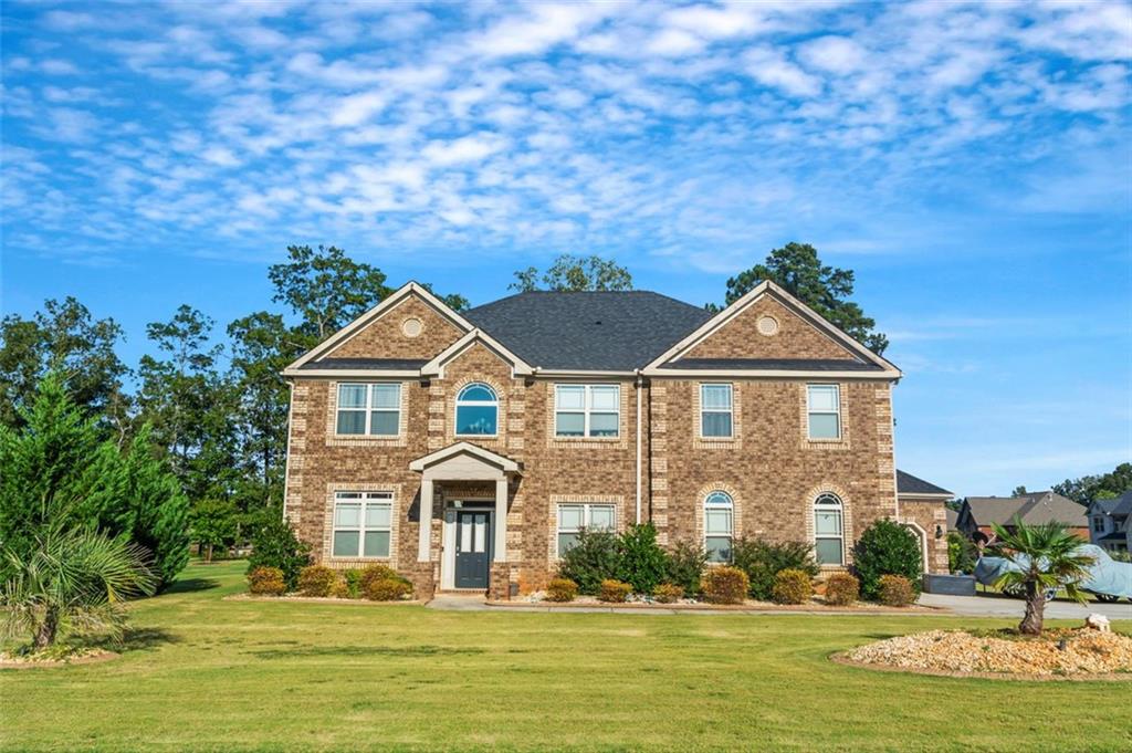 a front view of a house with a yard