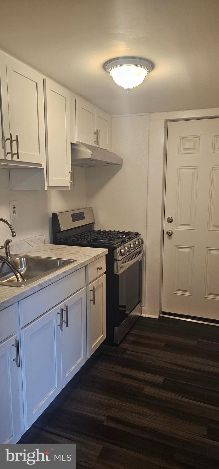 a kitchen with a sink and cabinets