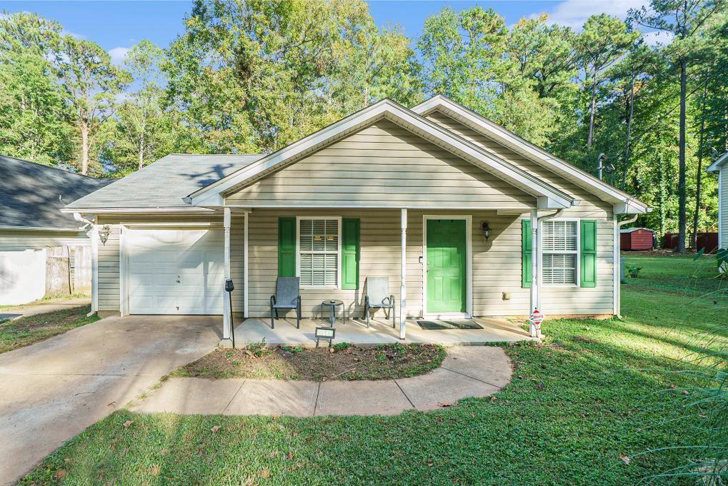 a front view of a house with garden and porch