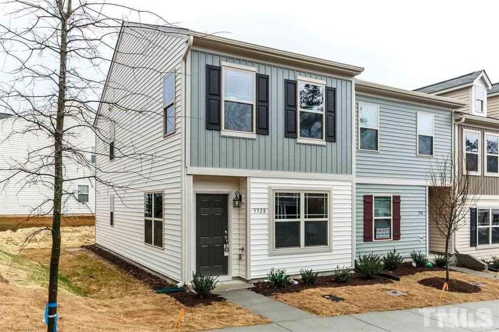 a front view of a house with yard and windows