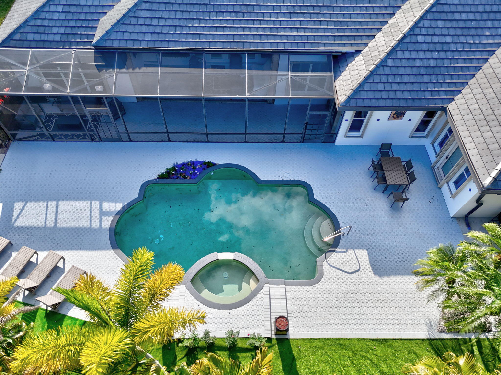 a view of a backyard with plants and a patio