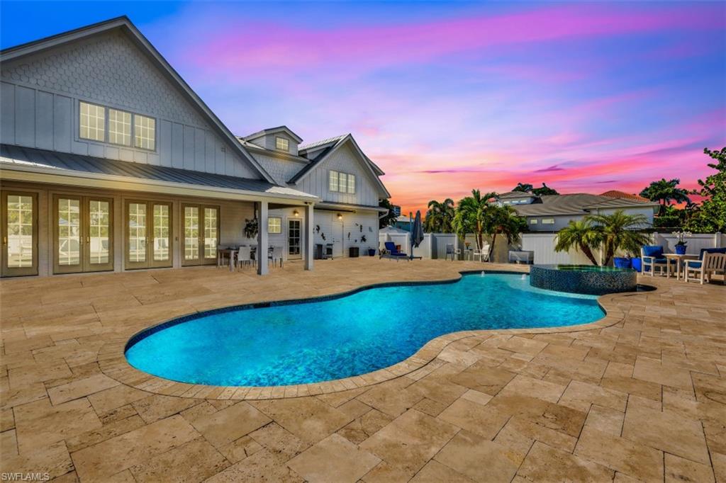 a view of a house with swimming pool and sitting area