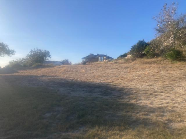 a view of dirt field and mountain view