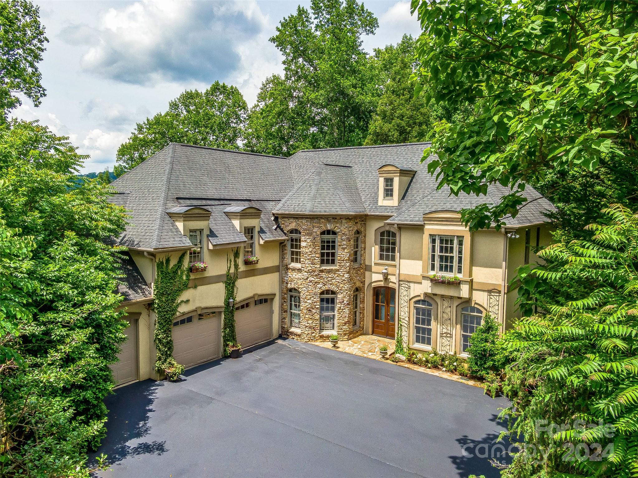 an aerial view of a house with a yard and potted plants