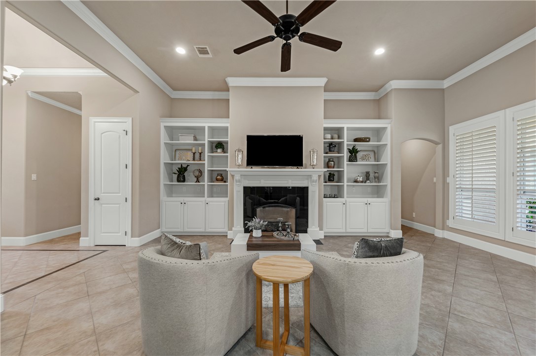 a living room with furniture a fireplace and a flat screen tv