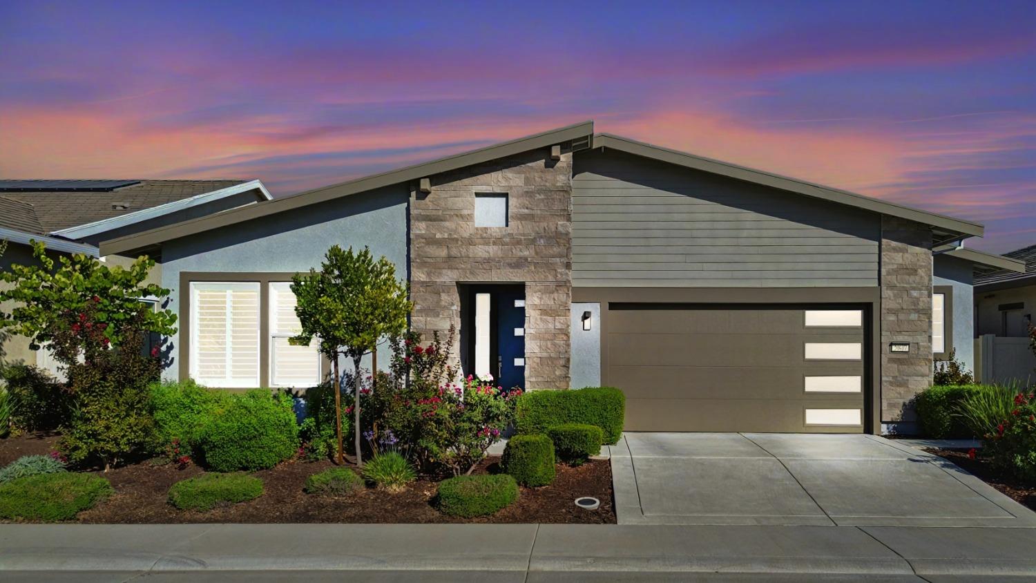 a front view of a house with garden